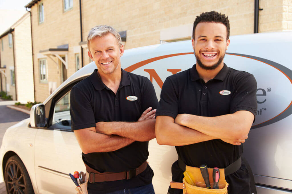 N-Hance franchise owners standing in front of van