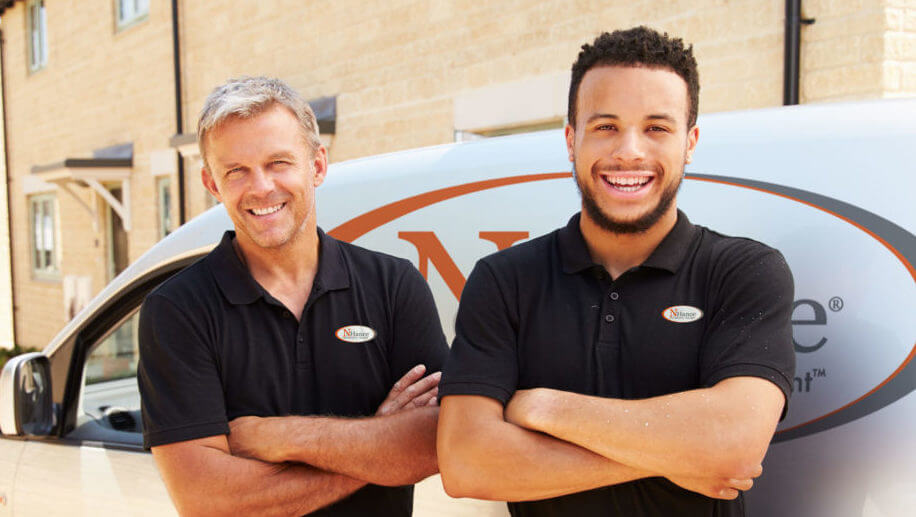 N-Hance franchise owners standing in front of van
