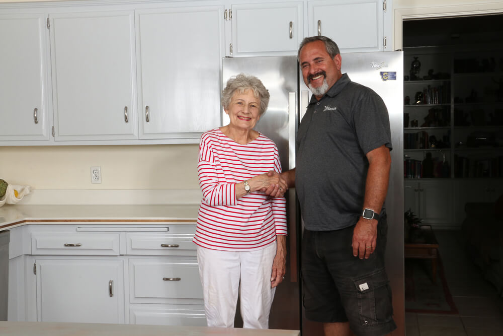Nhance franchise owner in kitchen with happy customer