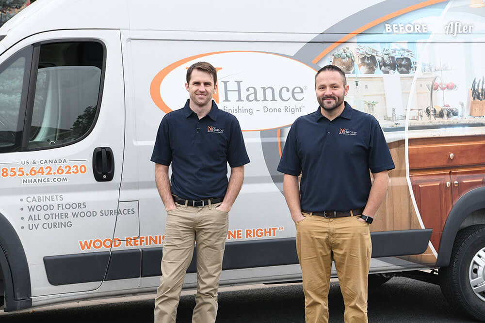 N-Hance wood franchise franchisees stand in front of van