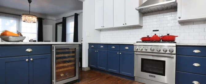N-Hance blue and white kitchen with red pots and wine rack